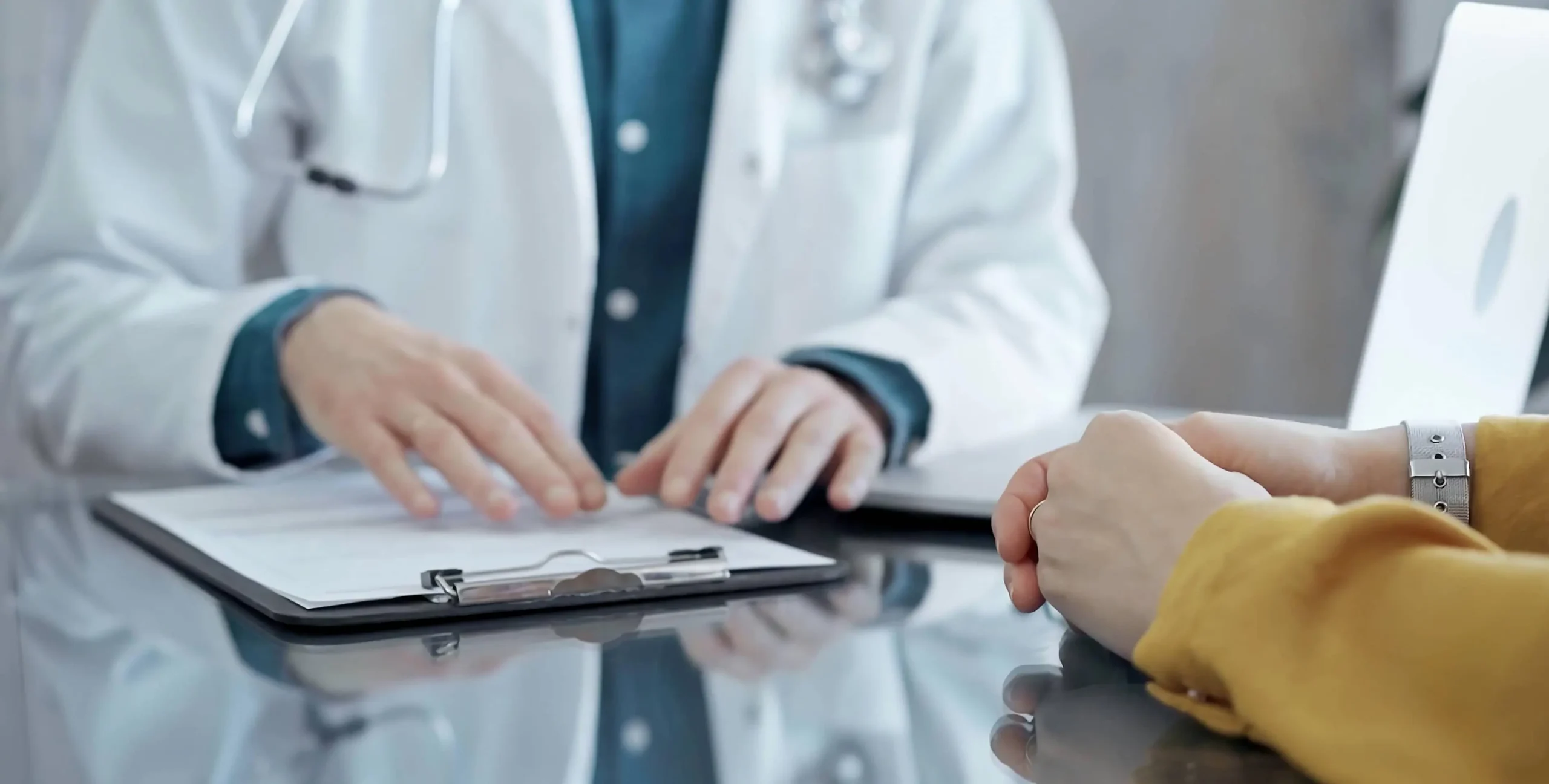 close up of a doctors hands while consulting with a patient