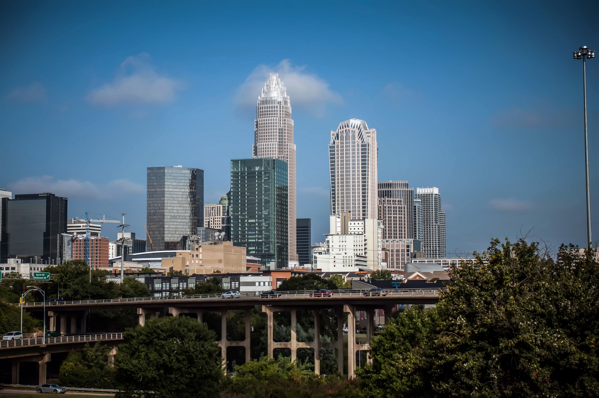 The Charlotte, North Carolina skyline showing several sky scrapers and a blue sky.